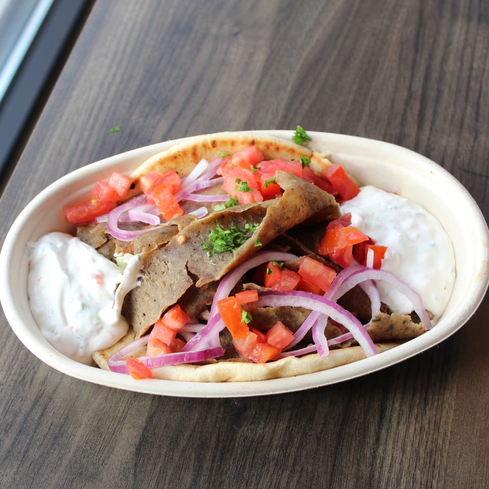 Baba Dari Mediterranean Grill's gyro with meat, tomatoes, red onions, and tzatziki sauce.