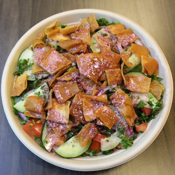 A Baba Dari Mediterranean Grill fattoush salad with crisp pita, cucumbers, tomatoes, and red onions.